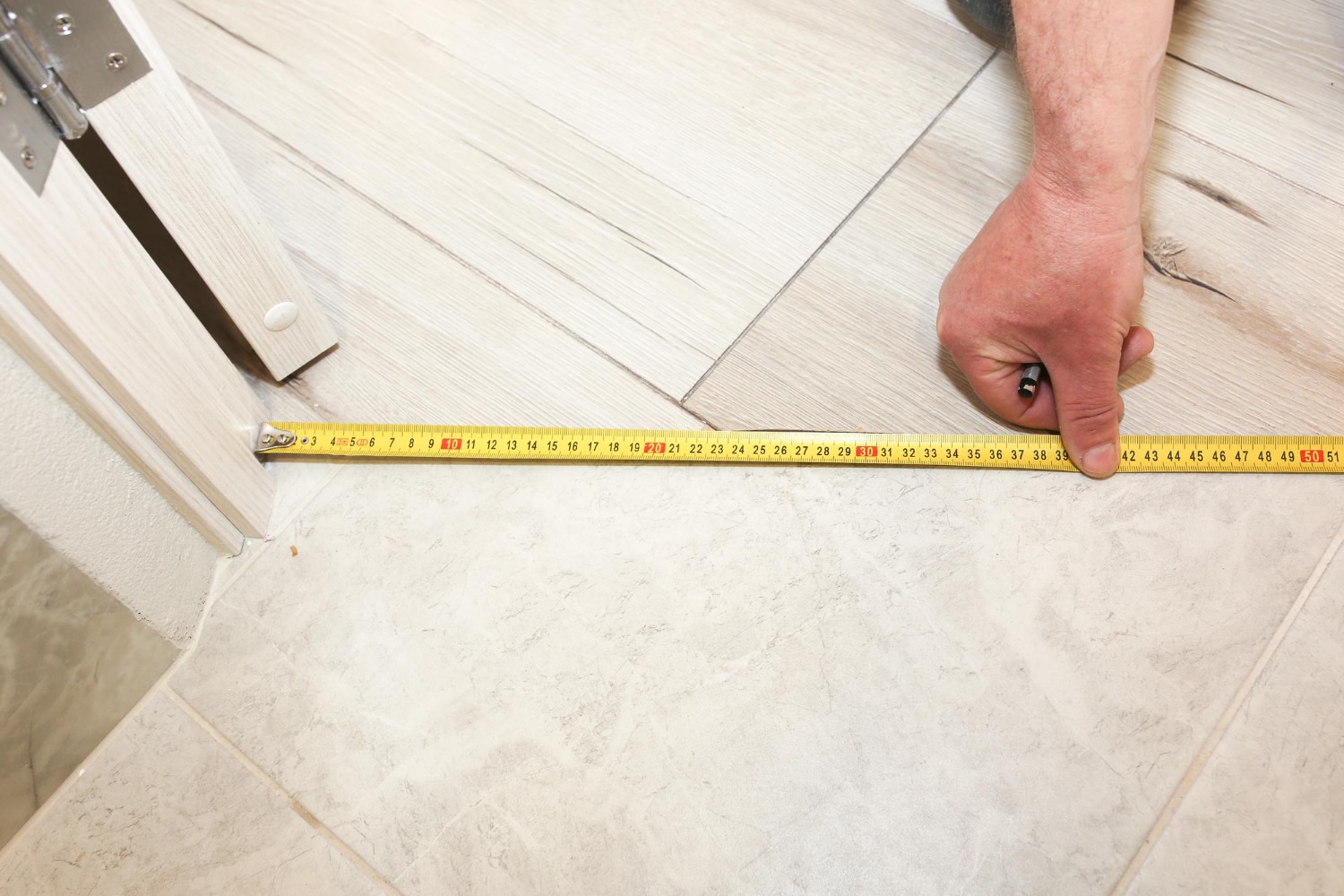 installation threshold indoors man with measuring tape renovation works flat